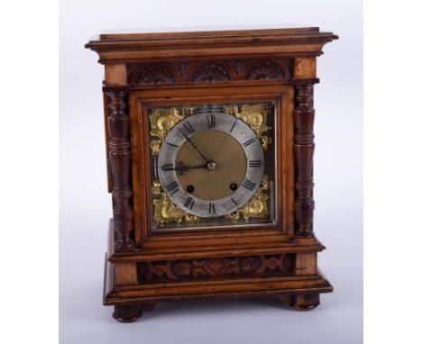 A Victorian carved walnut mantle clock, eight day movement, with key, 35cm.