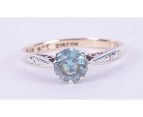 A 9ct yellow &amp; white gold ring set with a round cut blue zircon, 1.76gm, size J.