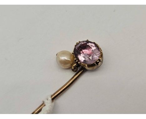 A gold mounted stick pin with foil back amethyst and pearl