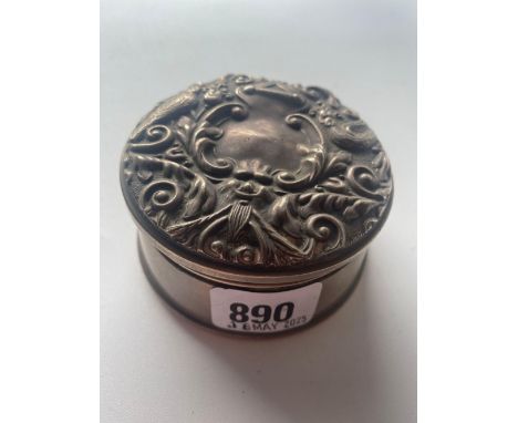 A embossed topped dressing table jar embossed with a bird amongst scrolls 3 ½ inches diameter