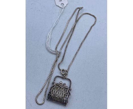 A silver coin purse pendant necklace with 1933 sixpence