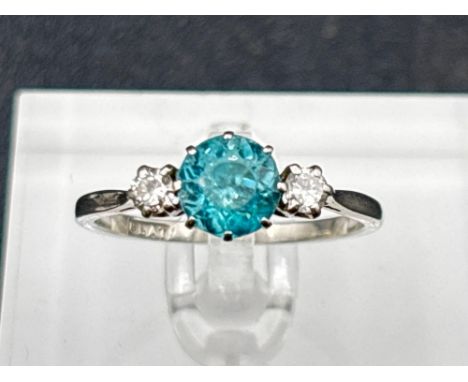 A diamond and blue zircon three stone ring set in platinum size Q 3.5 gms