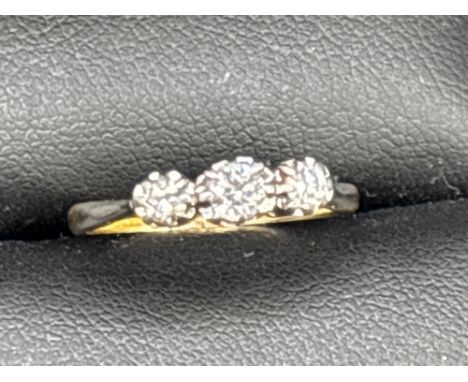 A bright 1920s three stone diamond ring in 18ct gold and platinum size I  2.2 gms