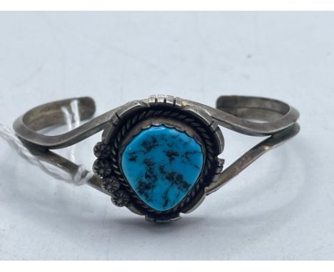 A silver and turquoise torque bangle