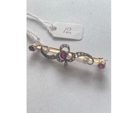 A antique diamond and ruby brooch set in gold