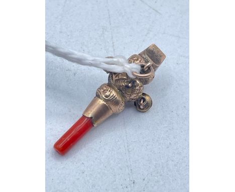 A MINIATURE GOLD AND CORAL VICTORIAN RATTLE WHISTLE 9CT