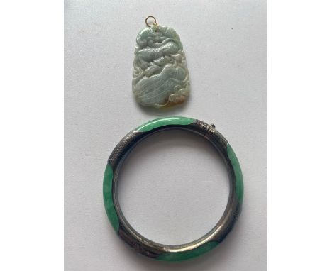 A silver jade bangle and  carved jade pendant