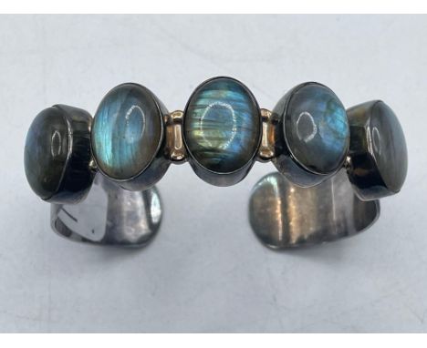 A impressive silver torque bangle with five labradorite stones  