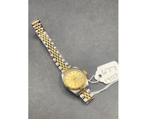 A LADIES ROLEX OYSTER PERPETUAL DATE JUST WRIST WATCH WITH SECONDS SWEEP AND DATE APERTURE ON BI METAL LINK STRAP
