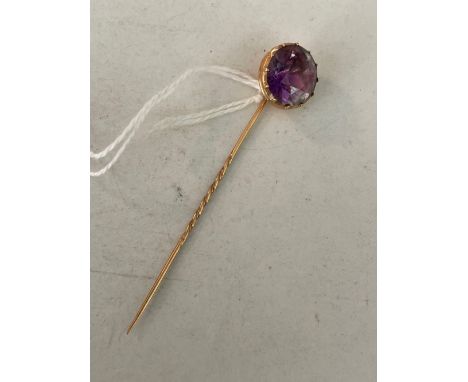 A gold antique amethyst stick pin