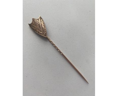 A shield shaped stick pin in gold 2.3 gms