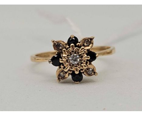 A sapphire and diamond ring size P 18ct gold 2.1 gms