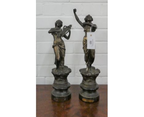 Two Spelter female figures on wooden bases, one dancing and one playing the lyre. Tallest is 43cm high.