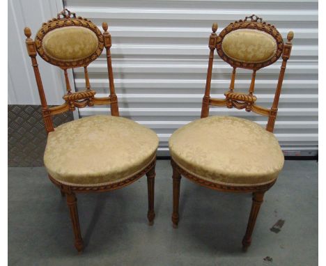 A pair of French light oak hall chairs with upholstered seats and back on four fluted cylindrical legs