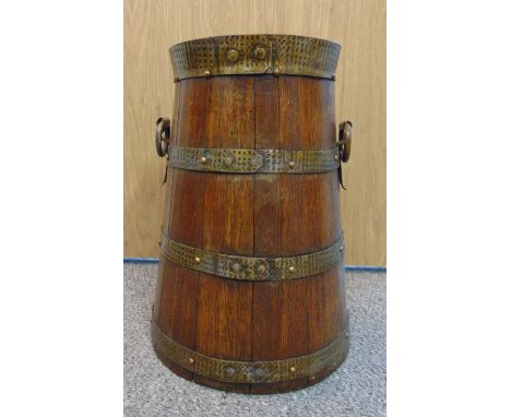 An oak coppered umbrella and stick stand of tapering cylindrical form with pierced side handles, 41cm (h)