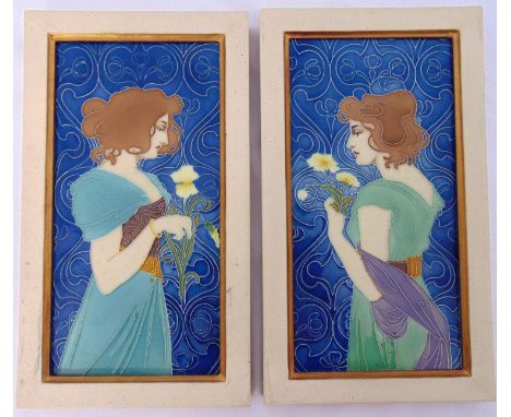 A pair of rectangular framed Art Nouveau style ceramic panels with tube line decoration depicting ladies holding flowers, 35 