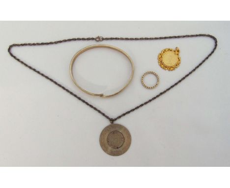 A quantity of costume jewellery to include a hallmarked silver bangle, an eternity ring and two pendants