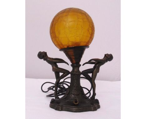 A cast metal Art Deco style figural table lamp in the form of two ladies holding a globular glass shade, 27.5cm (h)