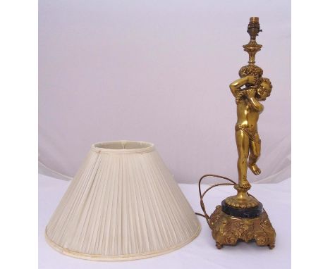 A gilt metal figural table lamp on raised base to include shade, 62cm (h)