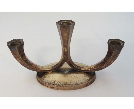 A continental white metal three light candelabrum of panelled scroll form on raised oval base, approx weight of white metal 2
