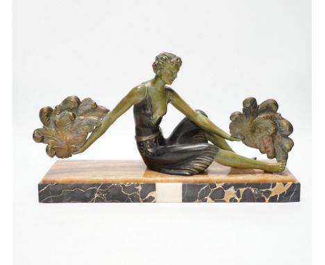 An Art Deco patinated spelter and marble figure, signed A. Leclerc, 40cm wide