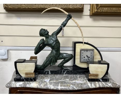 A French Art Deco bronzed spelter archer and cream and black marble mantel clock garniture, 50cm high
