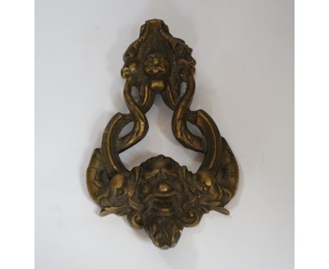 A 19th century rococo cast brass door knocker, 23cm long