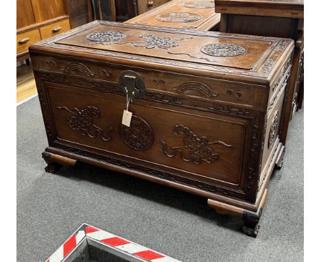 An Asian carved camphorwood trunk, width 100cm, depth 49cm, height 64cm