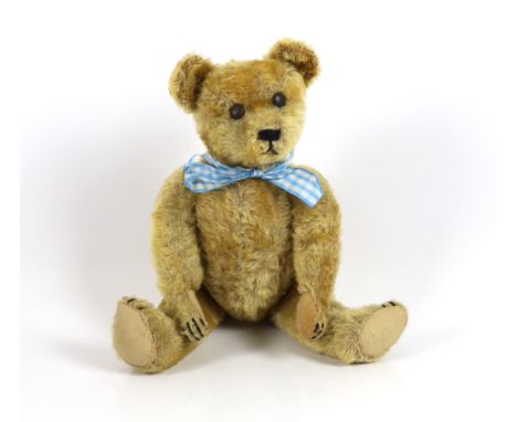 An early German bear, c.1920, with set in ears, black button eyes, 35cm, replaced paw pads, otherwise good condition