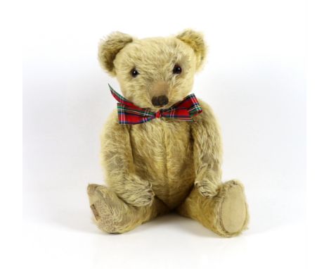 A 1930's Merrythought bear, with label, 44cm, old repair to foot, some hair loss