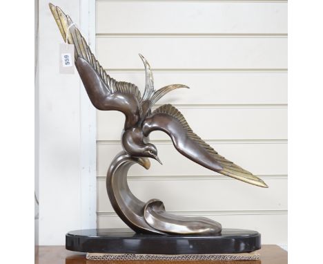 An Art Deco French patinated spelter figure of a bird in flight, signed Rochard to base, 60cm high
