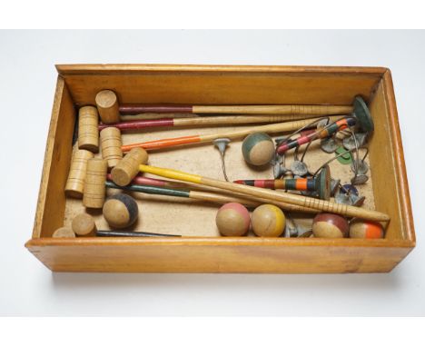 A boxed table croquet set with eight painted bats and six balls