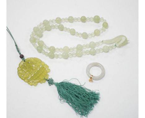 A bowenite jade bead necklace with dragon head clasp, circular pendant and carved disc