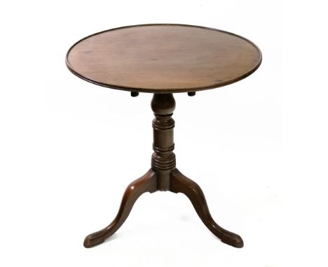 A George III style mahogany tea table, the moulded edge circular tilt-top, on a baluster and ring turned pillar and tripod ba