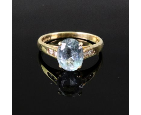 An 18ct gold and oval aquamarine single-stone ring with small two-stone diamond shoulders, size L, 2.8g gross.