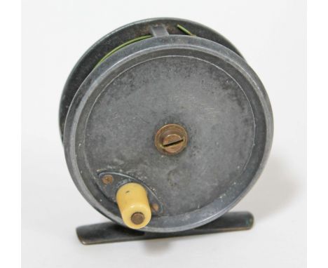 A fishing reel inscribed 'R Heaton Maker'.