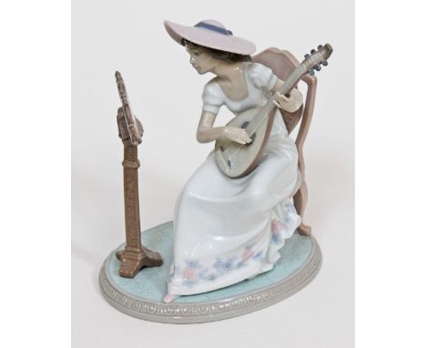 A Lladro figure formed as a girl playing the lute, height 21cm. Condition - very good, appears damage/repair free, minor wear