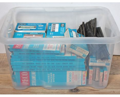 A box of approx. 40 Peco model railway OO gauge boxed track and wagon kits.