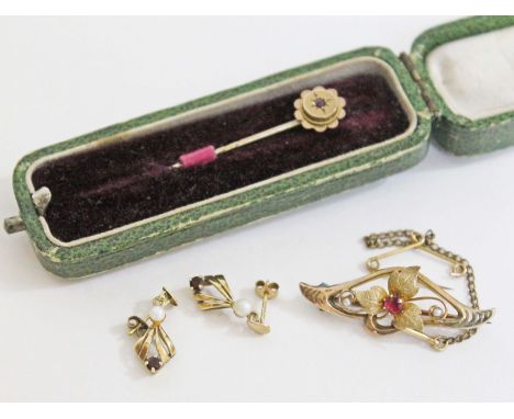 A mixed lot of yellow metal comprising a pair of earrings marked '375', a brooch unmarked and a stick pin marked '9ct', gross