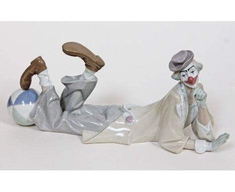 A Lladro figure of a reclining clown, length 38cm. Condition - good, no damage/repair, minor wear to include dirt.