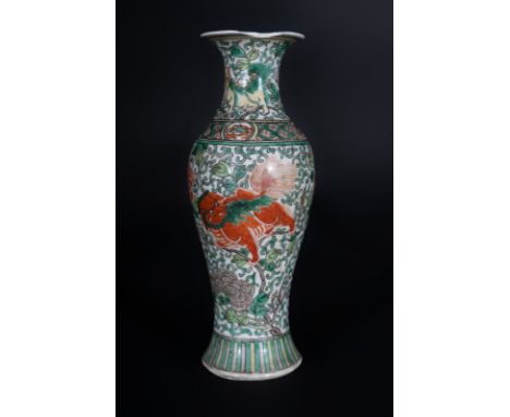 Chinese Art A wucai porcelain baluster vase painted with pho dogs among sprays and bearing a double circle mark at the base C