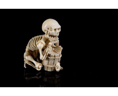 Japanese Art An ivory netsuke depicting a skeleton on a barrel. Signed at the base.Japan, 19th century . . Cm 3,70.