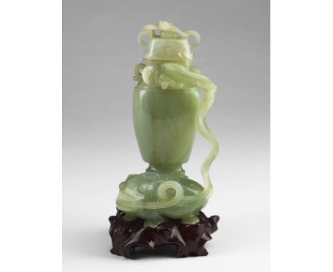 Chinese Art A jade carving in the shape of a lidded vase with leaves and flowers China, late 19th- 20th century . . Cm 10,00 