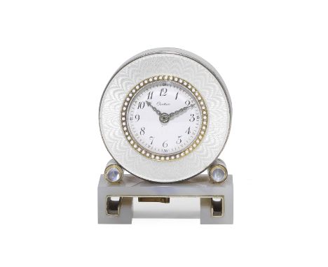 CARTIER: ENAMEL AND AGATE DESK CLOCK, CIRCA 1910Of circular outline, the white guilloché enamel surround with white enamel bo