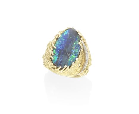 GRIMA: BOULDER OPAL AND DIAMOND DRESS RING, 1977The oval boulder opal in a pierced mount of textured wire with brilliant-cut 