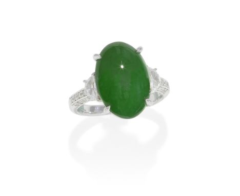 JADE AND DIAMOND RINGThe oval jade cabochon, between demi-lune shaped diamonds and brilliant-cut diamond shoulders,  diamonds