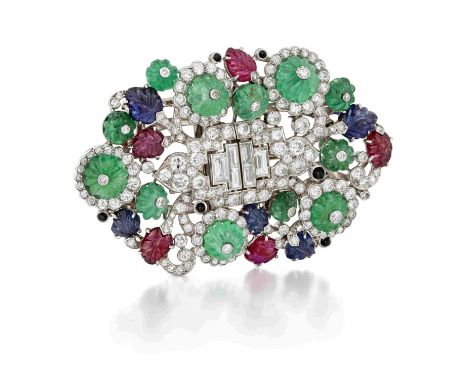 HENRI PICQ: MULTI GEM-SET AND DIAMOND TUTTI FRUTTI  DOUBLE-CLIP/BROOCH, CIRCA 1930Each openwork shield-shaped clip composed o