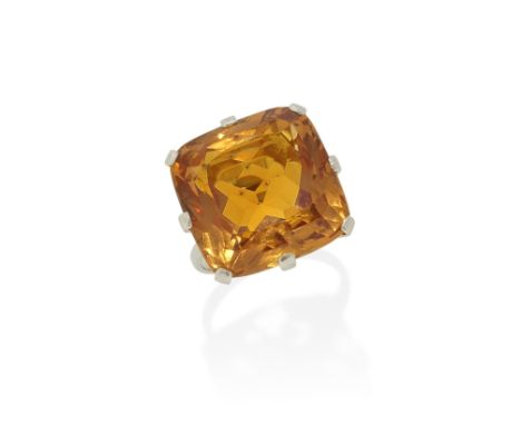 IMPERIAL TOPAZ RING, FIRST HALF OF THE 20TH CENTURYThe large cushion-shaped topaz, weighing 37.16 carats, in an eight-claw se