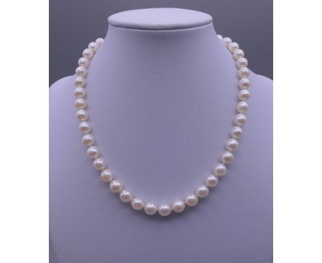 A pearl necklace with a diamond and pearl set unmarked white gold clasp. 38 cm long.