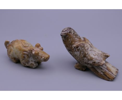 A Chinese carved jade bird and a Chinese carved jade pig. The former 8.5 cm long.